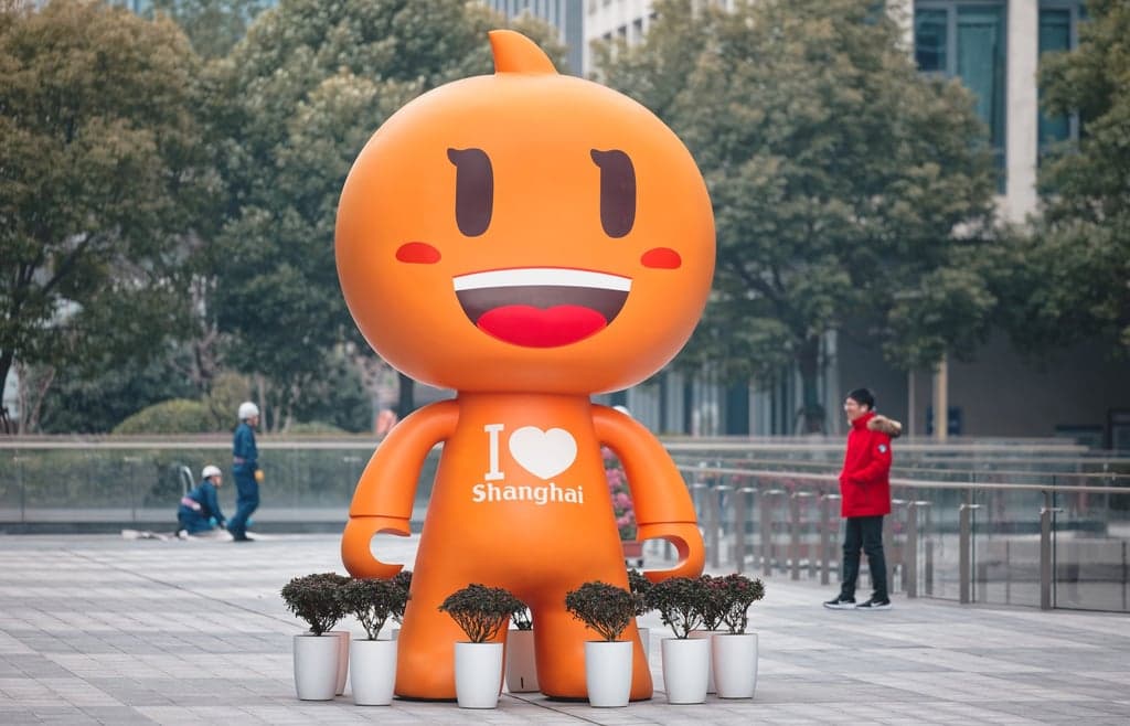 Conceptual image showing Apple and Alibaba logos overlaid on a circuit board, representing their AI partnership.