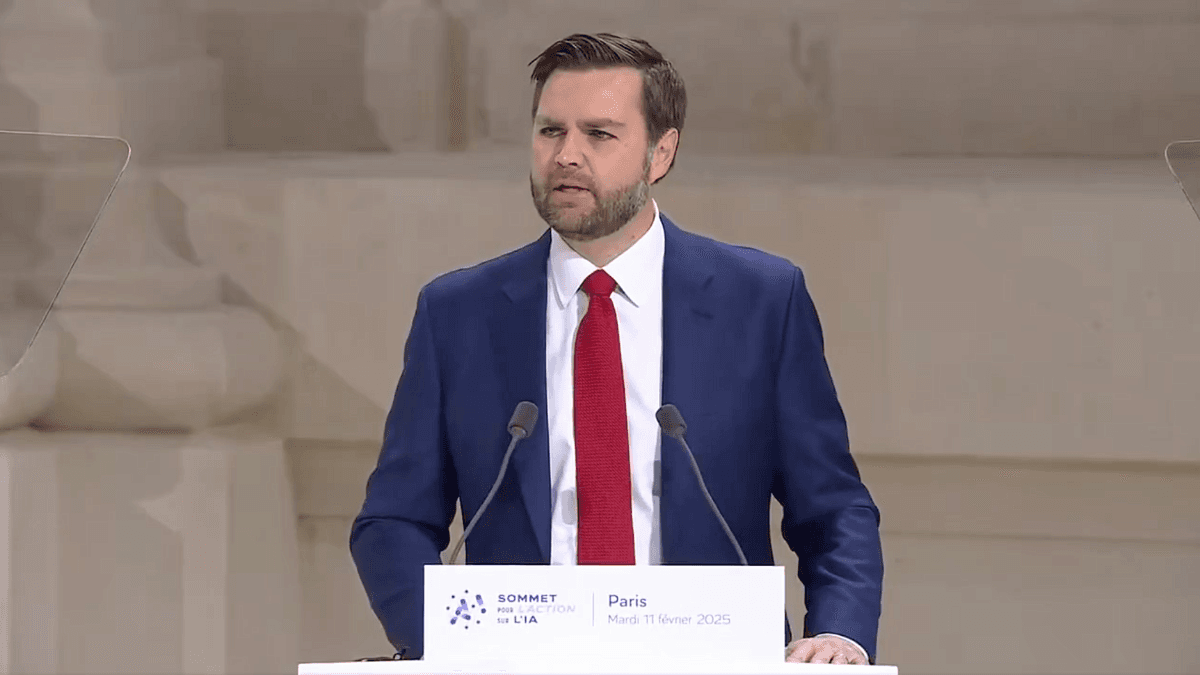 Panel discussion at the Paris AI Summit, featuring multiple speakers on a stage with a blue backdrop.